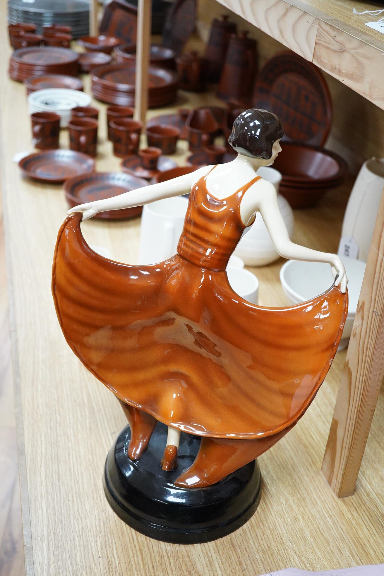 A Lorenzl Goldscheider butterfly dancer figurine, stamped to the base, restored, 42cm high